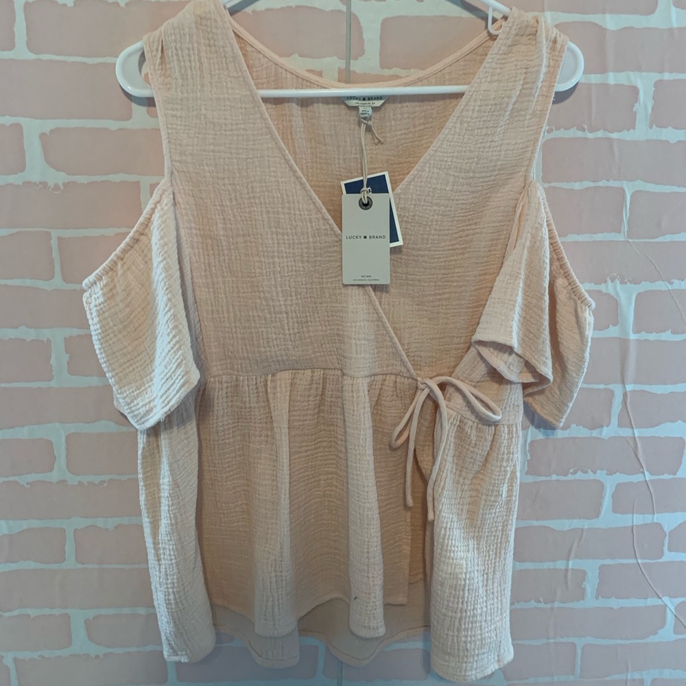 Off the shoulder light pink top.